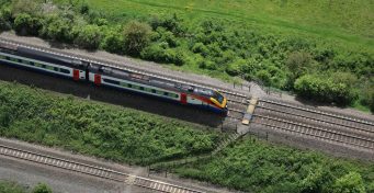 Aerial view of Souldrop level crossing with passing train