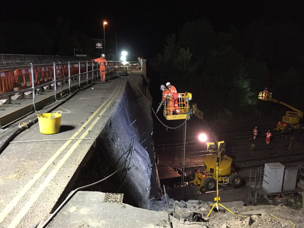 Workers conducting bridge works using an elevated platform