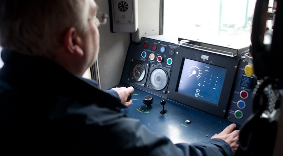 A man driving a train with signalling technology installed